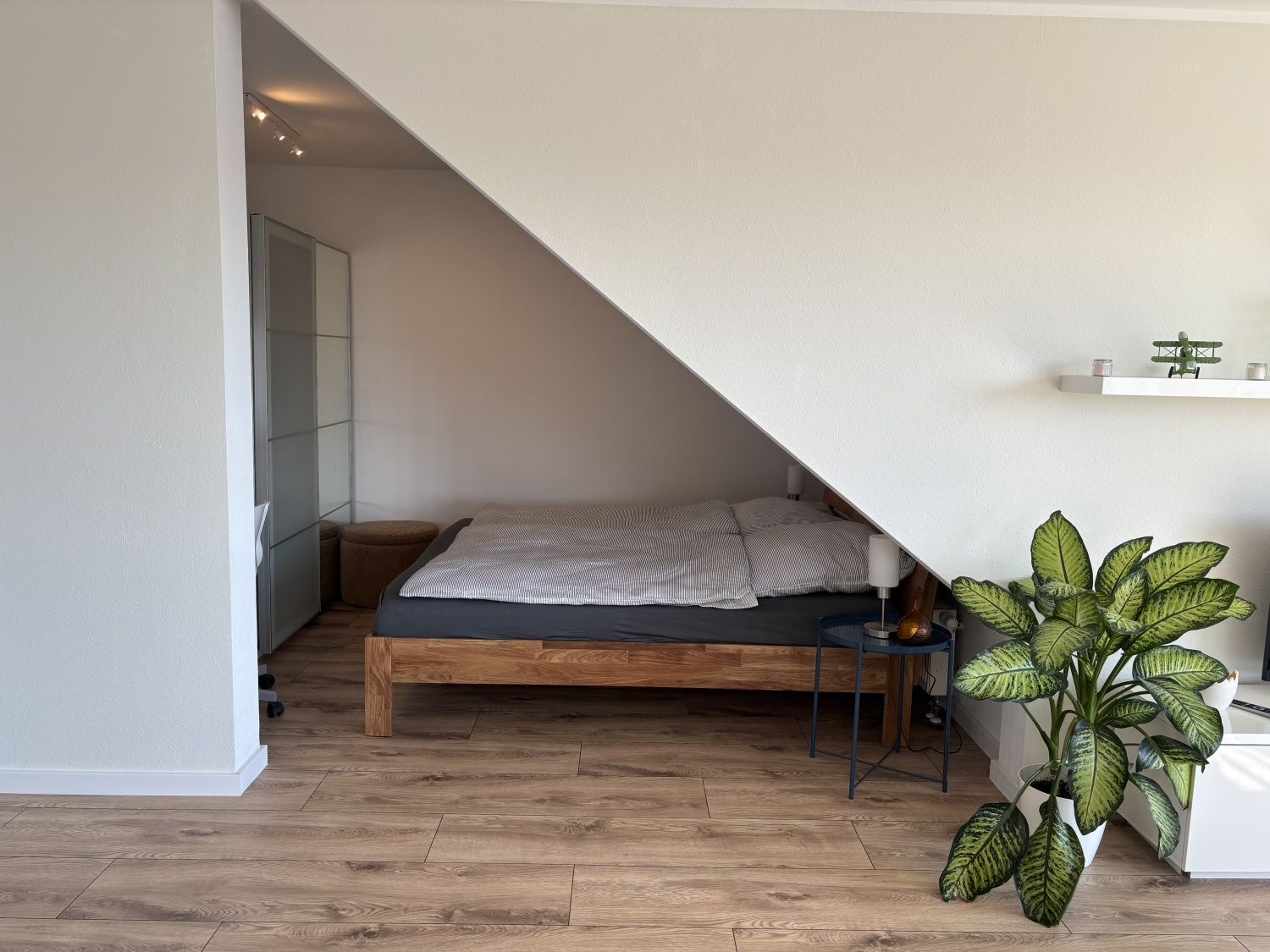 Schlafbereich unter der Dachschräge mit Doppelbett aus Holz